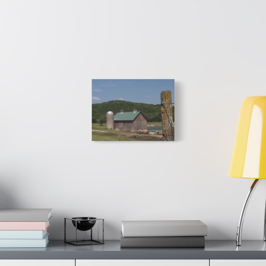 Rustic Barn Matte Stretched Canvas — Blurred Farm Landscape with Barbed Wire