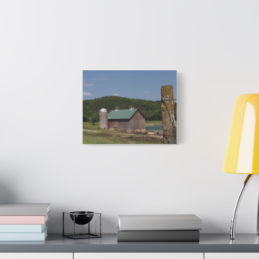 Rustic Barn Matte Stretched Canvas — Blurred Farm Landscape with Barbed Wire