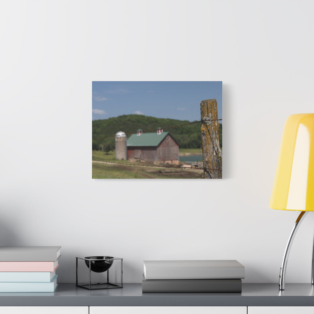 Rustic Barn Matte Stretched Canvas — Blurred Farm Landscape with Barbed Wire