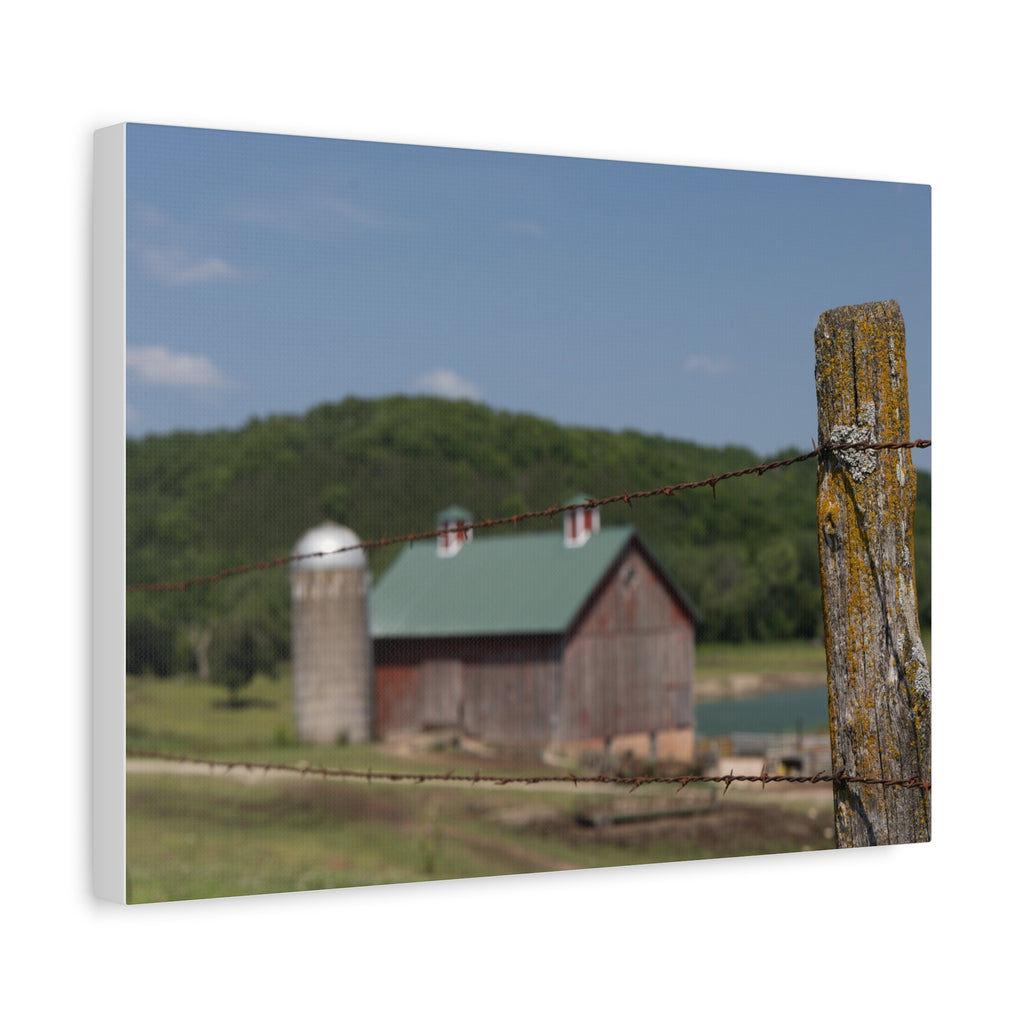 Rustic Barn Matte Stretched Canvas — Blurred Farm Landscape with Barbed Wire